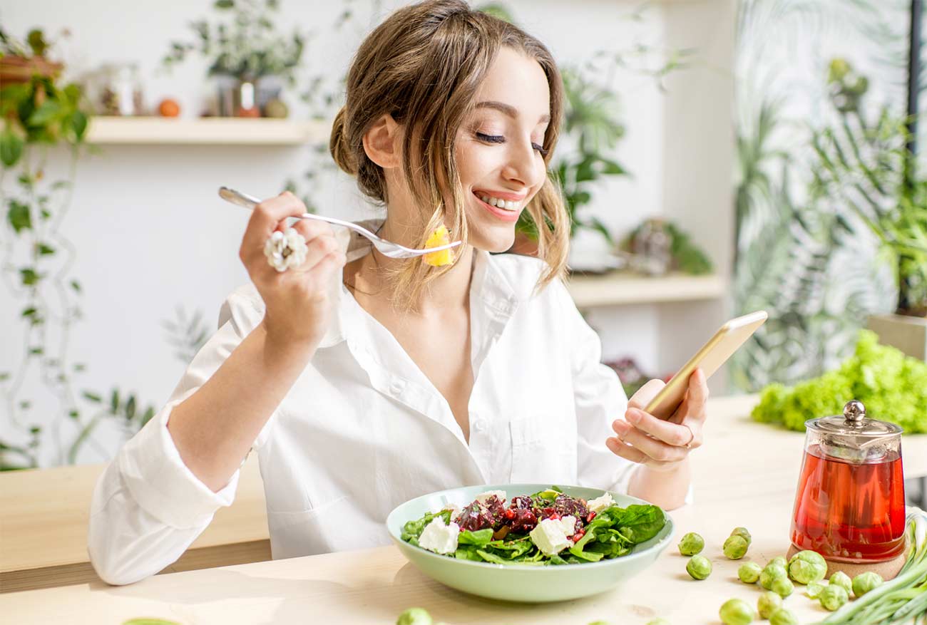 Mother eating healthy meal with fresh vegetables and fruits